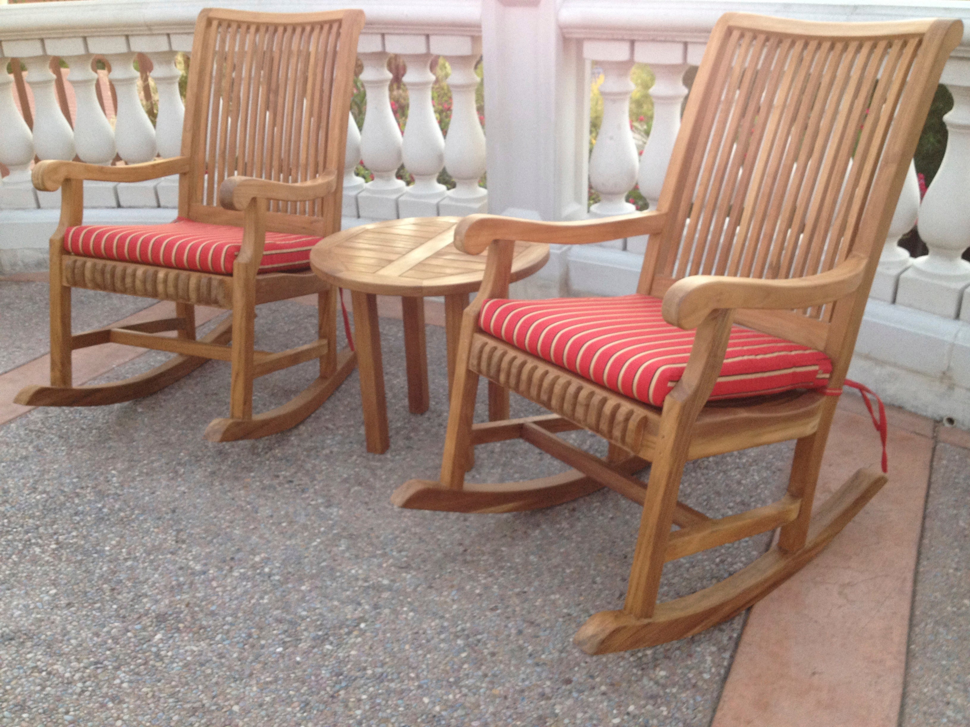 Photo of two teak rockers with teak table in between.