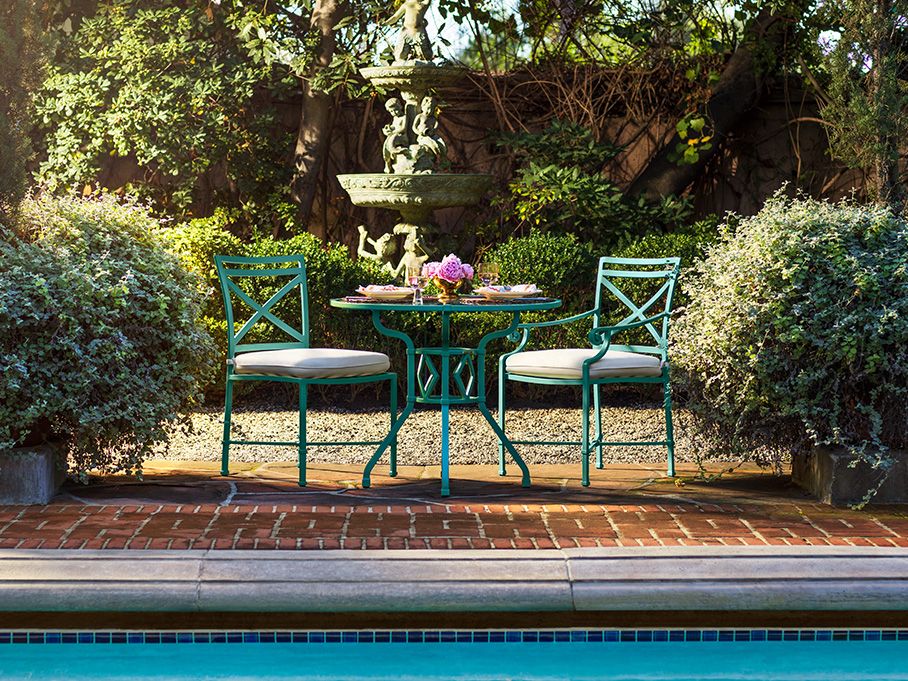Photo of 2 patio chairs with cushions in a backyard