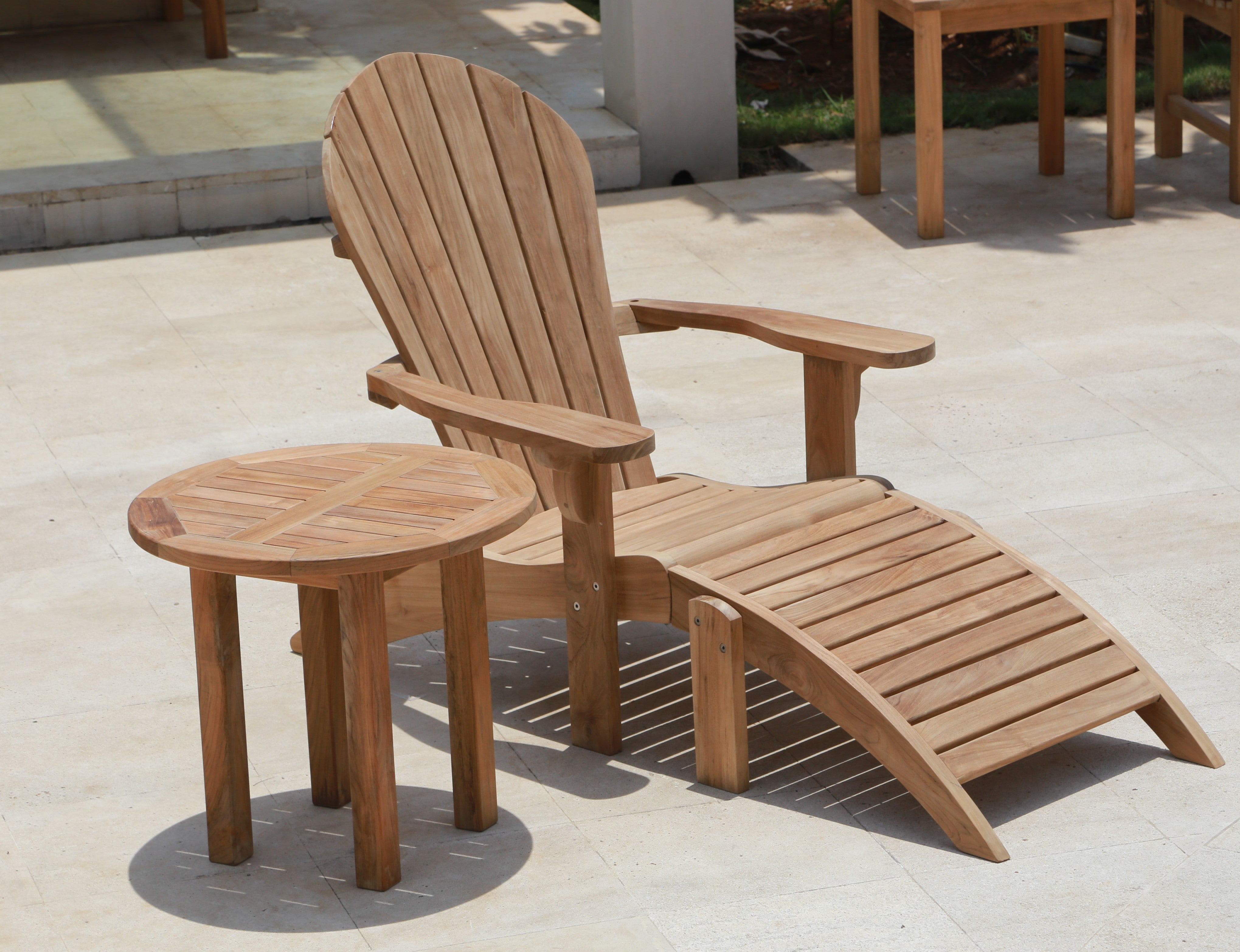 Photo of a teak lounfer with side table.