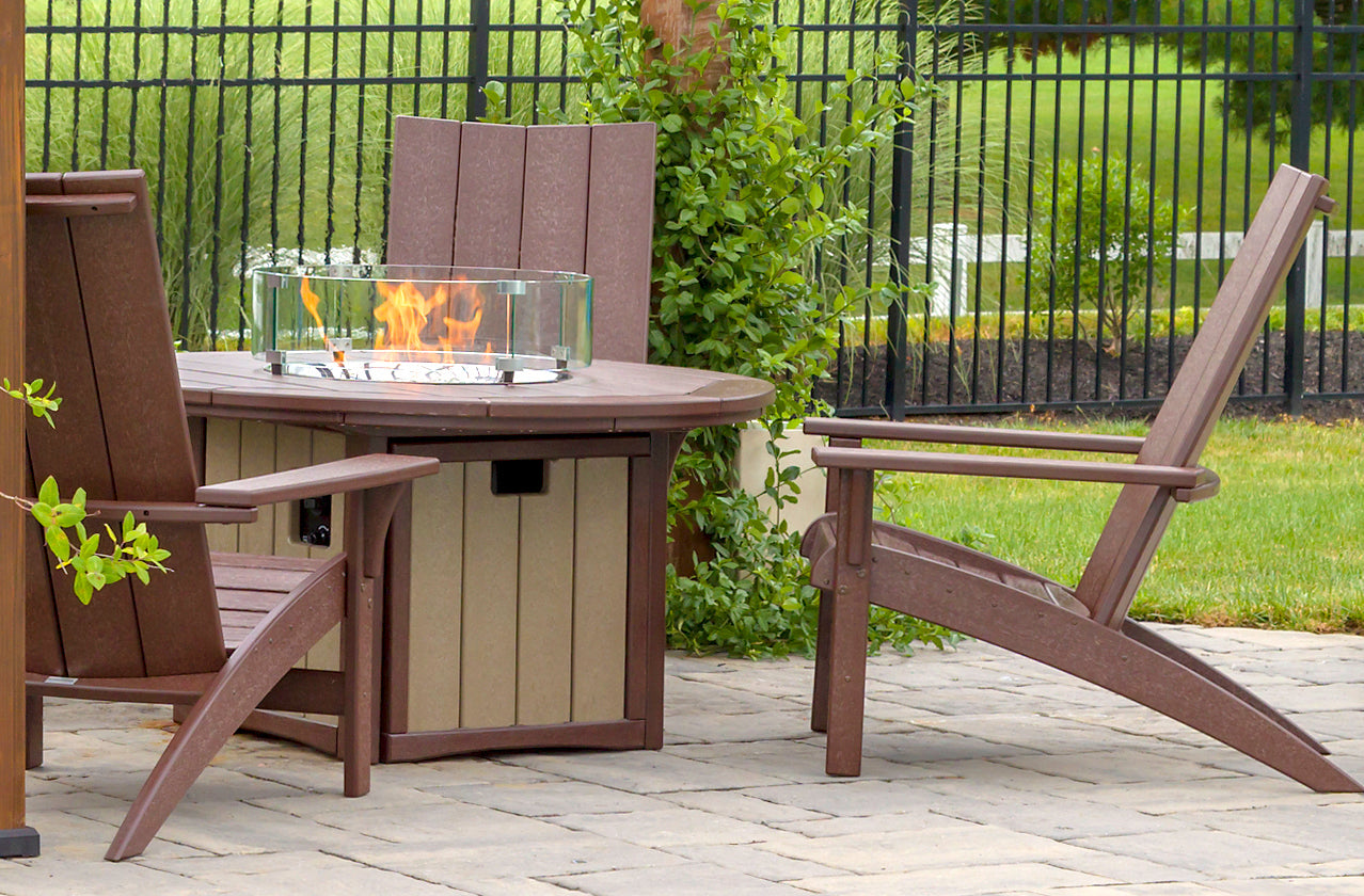 Outdoor patio set with Adirondack chairs and a fire pit table.