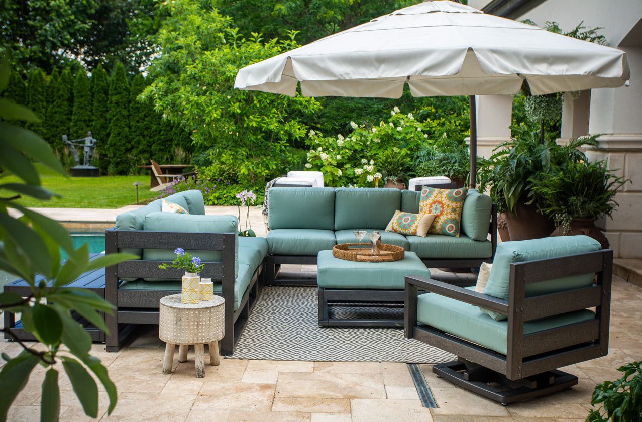 Elegant outdoor patio with stylish furniture and lush greenery.
