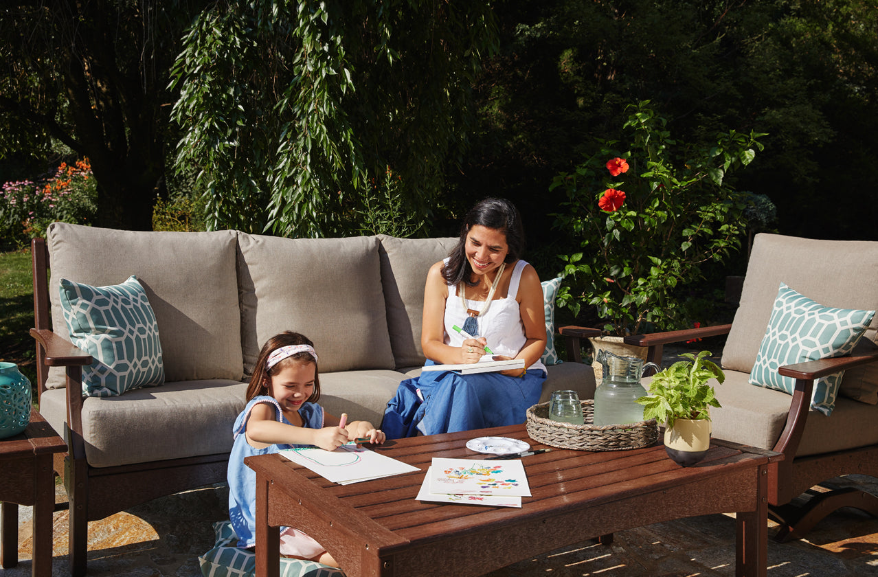Family sitting on outdoor patio furniture